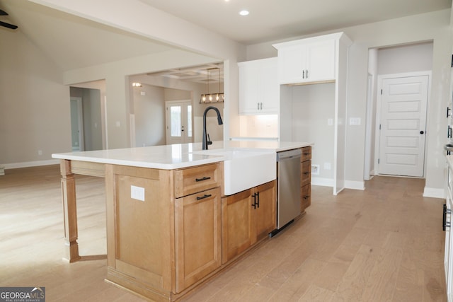 kitchen featuring white cabinetry, dishwasher, sink, light hardwood / wood-style floors, and a center island with sink