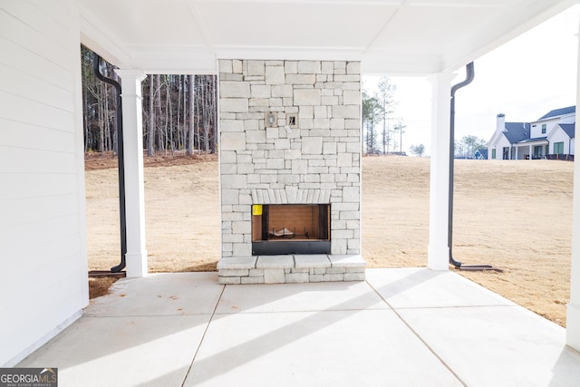 view of patio featuring an outdoor stone fireplace