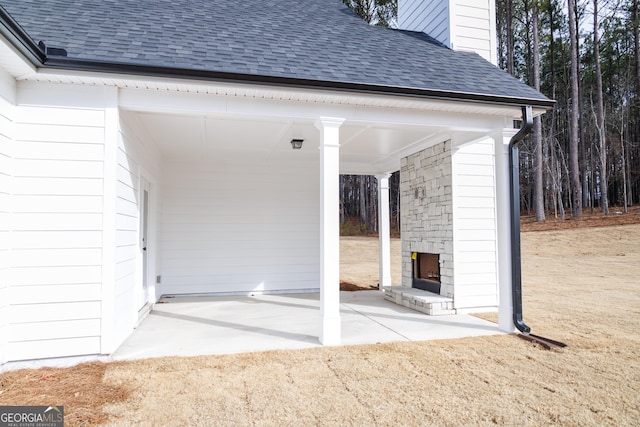 view of patio featuring a gazebo and an outdoor stone fireplace