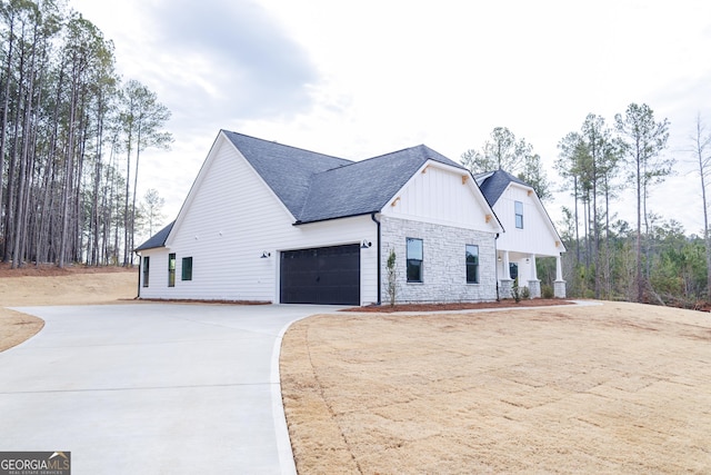 view of side of property featuring a garage and a porch