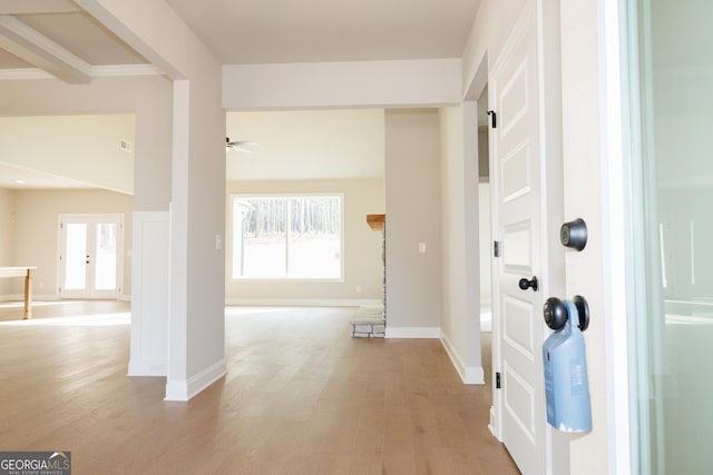 foyer with french doors, a healthy amount of sunlight, ceiling fan, and light hardwood / wood-style flooring