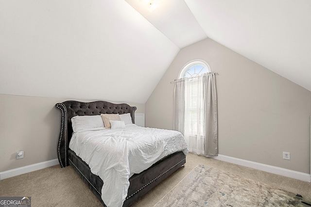 carpeted bedroom with vaulted ceiling