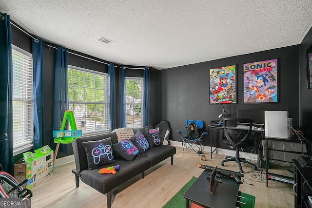 office area featuring light hardwood / wood-style floors and a textured ceiling