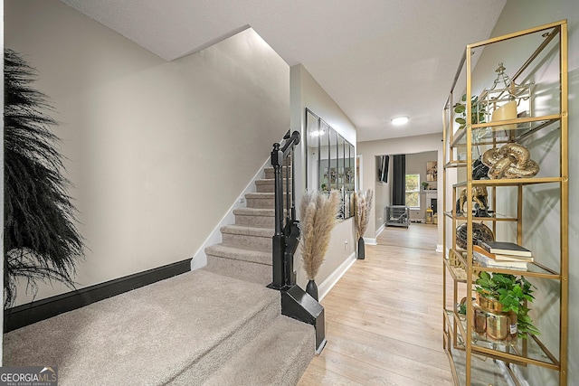 stairs with hardwood / wood-style floors