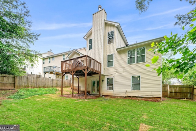 back of property featuring a yard and a wooden deck