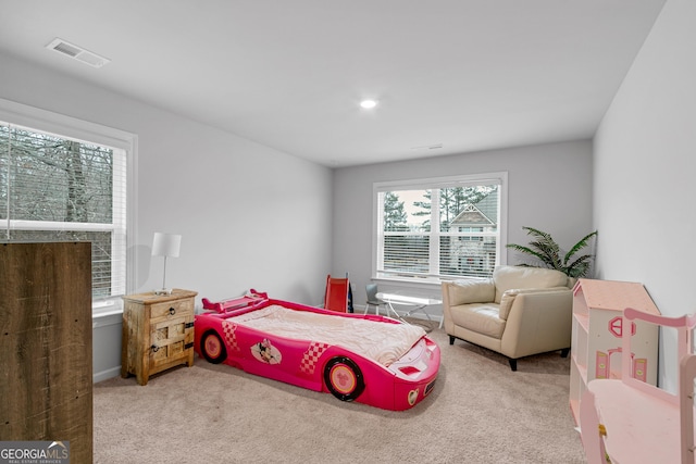 carpeted bedroom featuring multiple windows