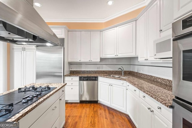 kitchen with sink, island exhaust hood, white cabinetry, and stainless steel appliances