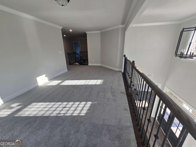 carpeted empty room with crown molding, plenty of natural light, and a notable chandelier