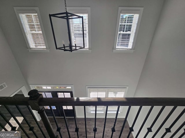 staircase with a chandelier