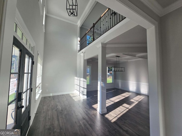 foyer entrance featuring french doors, crown molding, and dark wood-type flooring