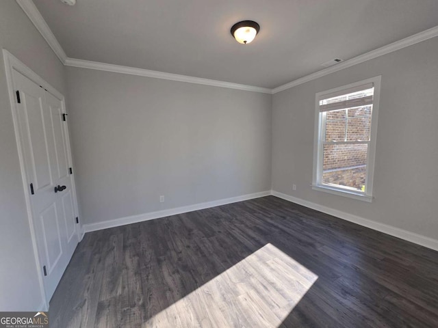 unfurnished bedroom with dark hardwood / wood-style flooring and crown molding