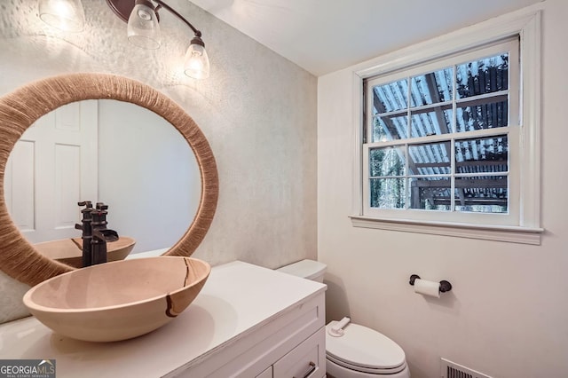 bathroom featuring vanity and toilet