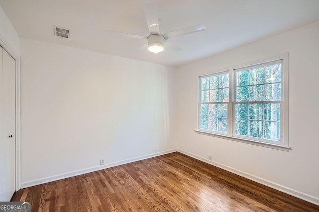 unfurnished room with hardwood / wood-style flooring and ceiling fan