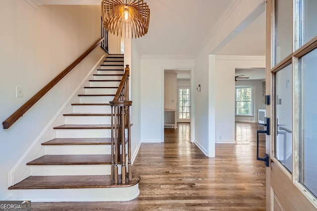 staircase featuring hardwood / wood-style flooring and crown molding