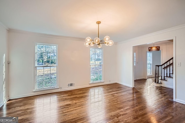 empty room with dark hardwood / wood-style floors, an inviting chandelier, and ornamental molding