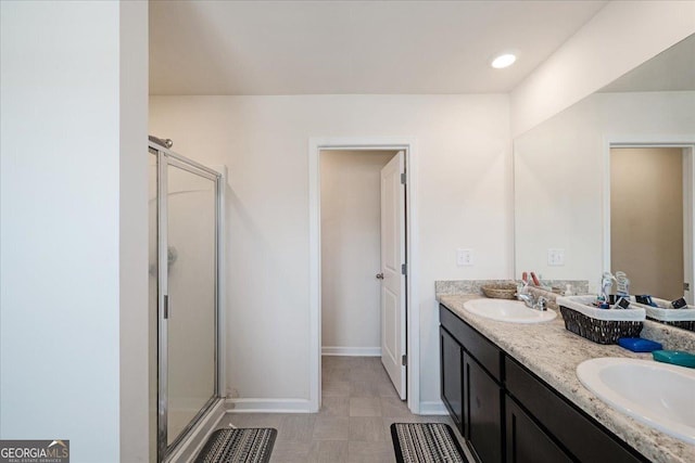 bathroom featuring tile patterned flooring, vanity, and a shower with door