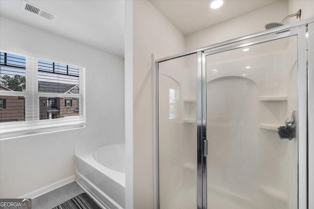 bathroom with tile patterned floors and separate shower and tub