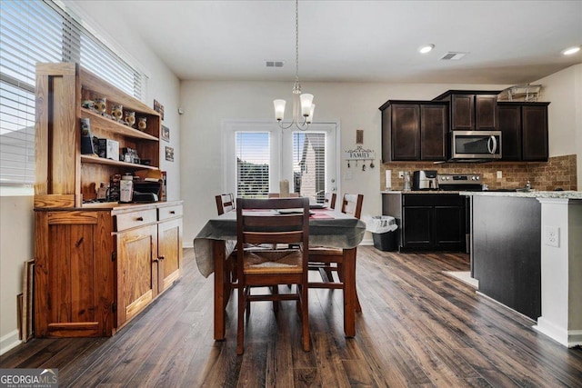 dining area with a notable chandelier and dark wood-type flooring