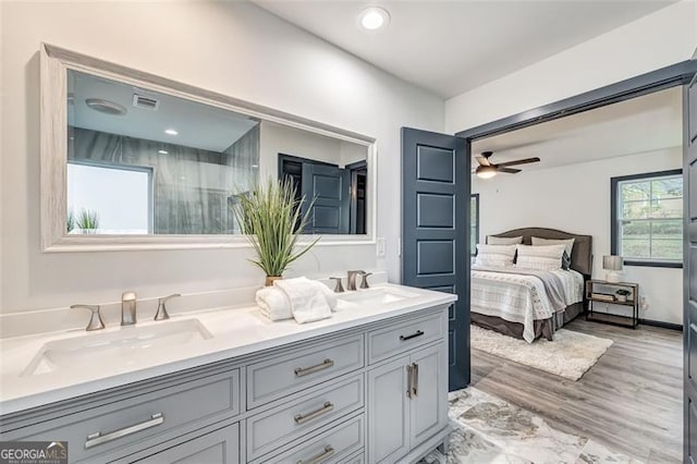 bathroom with ceiling fan, vanity, and hardwood / wood-style flooring