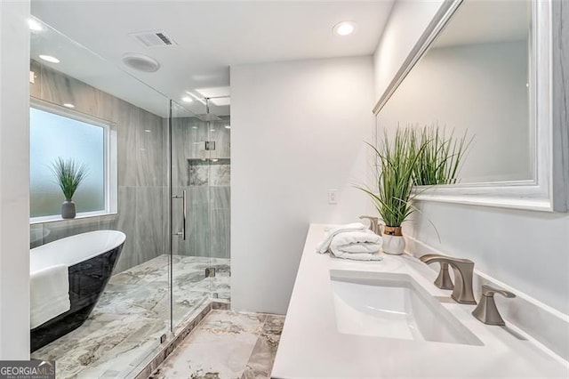 bathroom featuring shower with separate bathtub and vanity