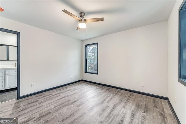 spare room with ceiling fan and light hardwood / wood-style floors