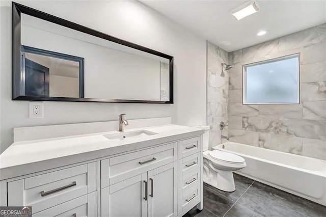 full bathroom featuring vanity, toilet, and tiled shower / bath