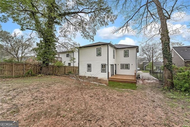 rear view of house featuring a deck