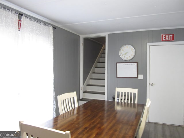 unfurnished dining area featuring hardwood / wood-style flooring and ornamental molding