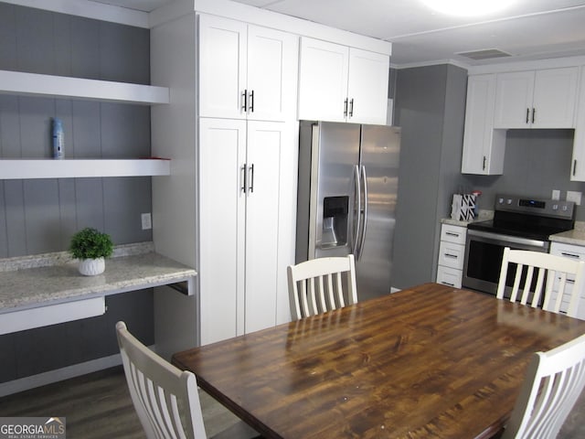 kitchen featuring light stone counters, white cabinets, dark hardwood / wood-style floors, and appliances with stainless steel finishes