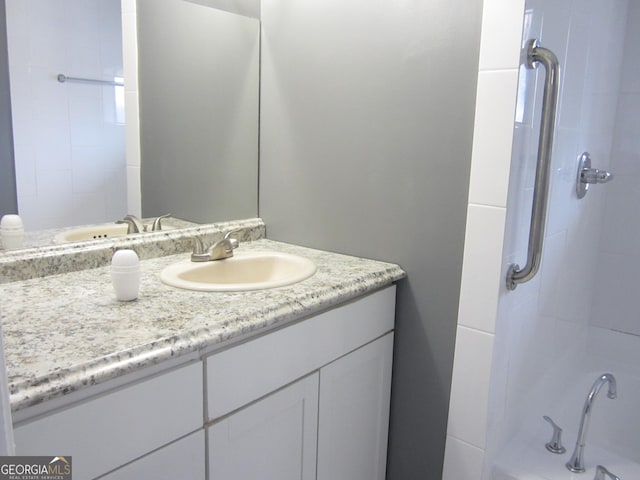 bathroom featuring vanity and tiled shower