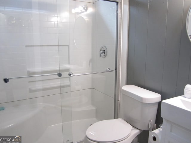 bathroom with toilet and a shower with shower door