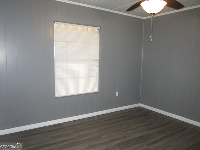 unfurnished room with crown molding, plenty of natural light, ceiling fan, and dark wood-type flooring