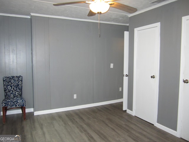 interior space featuring ceiling fan, dark hardwood / wood-style floors, and ornamental molding