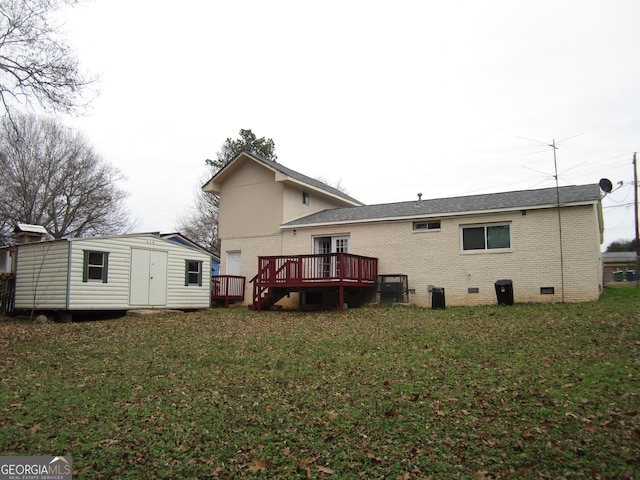 back of house featuring a lawn, central AC unit, a storage shed, and a deck