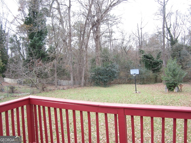 wooden terrace featuring a yard