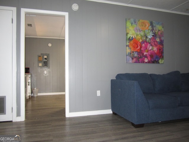 living room with electric panel, dark wood-type flooring, and ornamental molding