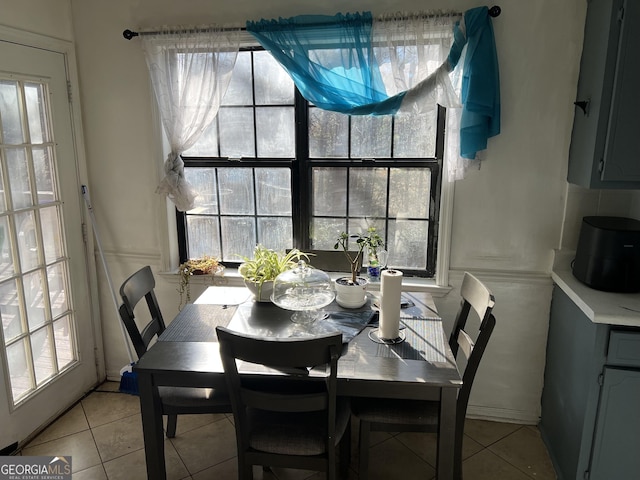 tiled dining space featuring a wealth of natural light