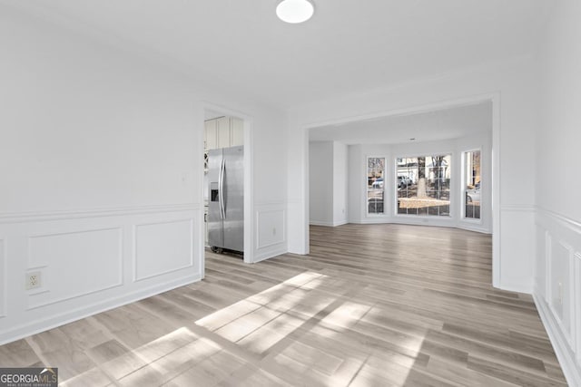 empty room with light hardwood / wood-style floors