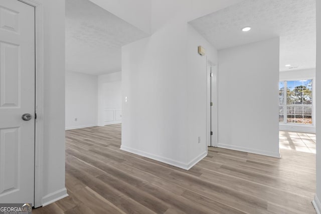 interior space featuring a textured ceiling and light wood-type flooring