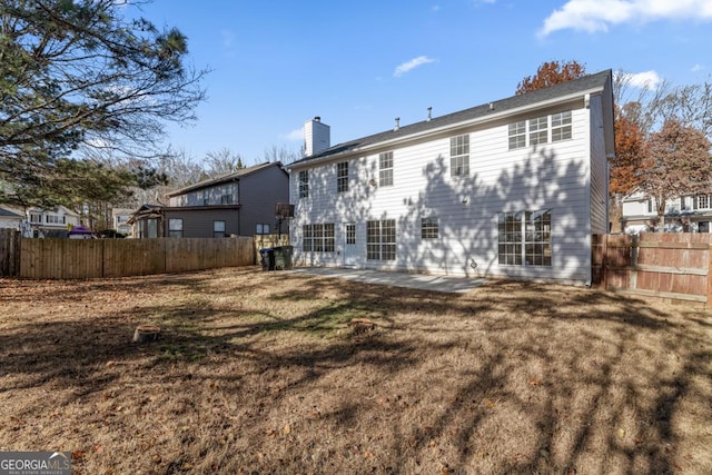 rear view of property with a lawn