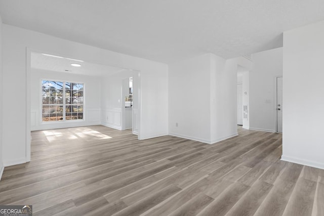 unfurnished living room featuring light wood-type flooring