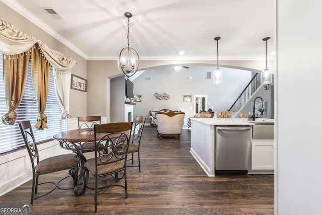 dining area with dark wood-style floors, visible vents, ornamental molding, and stairway