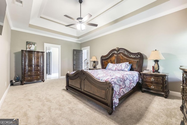 bedroom featuring baseboards, a tray ceiling, visible vents, and light colored carpet