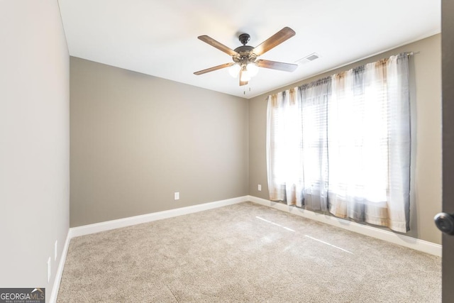 unfurnished room with a ceiling fan, carpet, visible vents, and baseboards