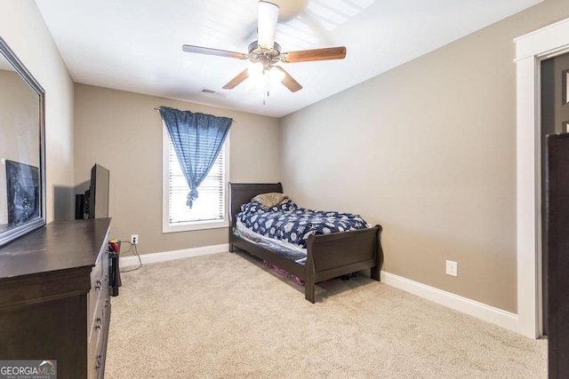 bedroom with baseboards, ceiling fan, and light colored carpet