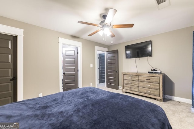 bedroom with baseboards, ceiling fan, visible vents, and light colored carpet