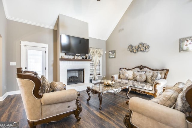 living room with baseboards, a glass covered fireplace, dark wood-style floors, crown molding, and high vaulted ceiling