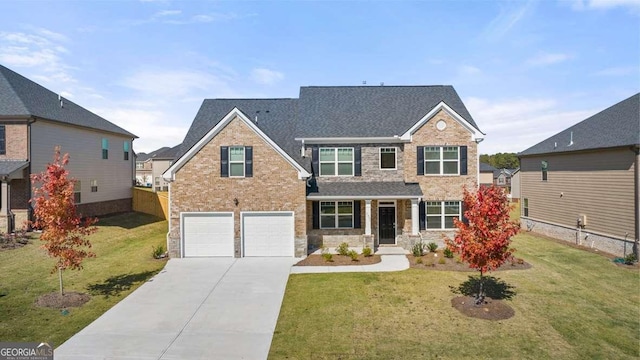 view of front of home with a front yard and a garage