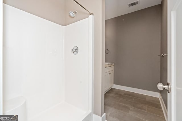 bathroom with a shower and vanity