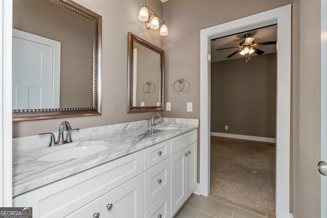 bathroom with tile patterned flooring, vanity, and ceiling fan